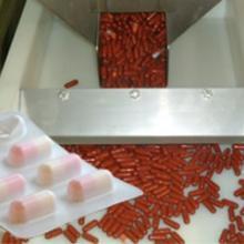 Transferência mecânica de cápsulas farmacêuticas